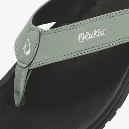 Seagreen and black thong sandal with embroidered brand logo and stitched toe post detail.