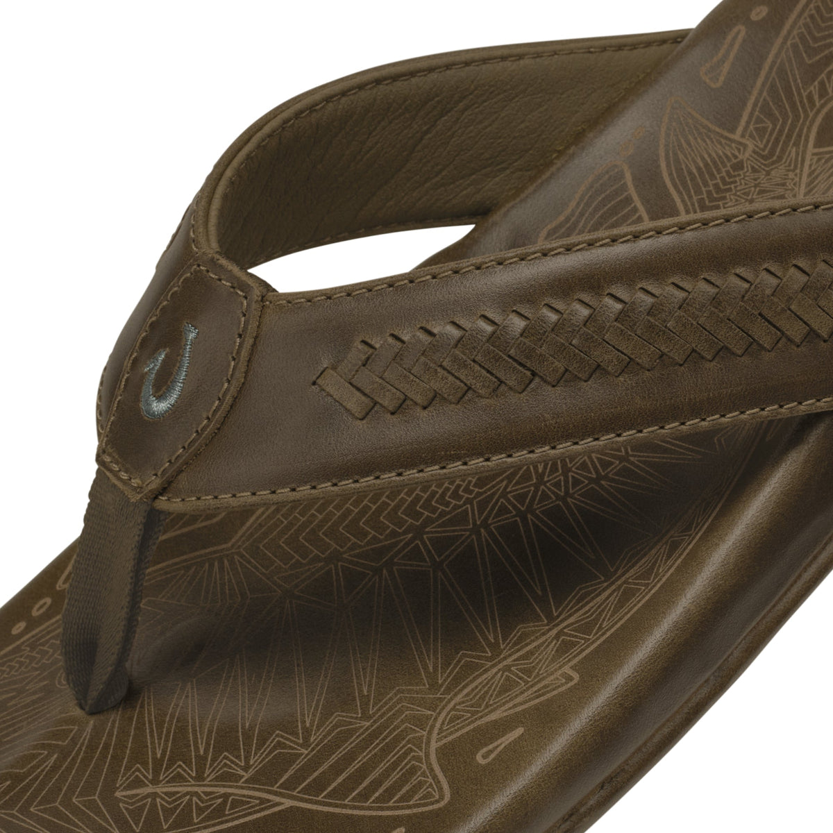 Tan leather thong sandal with geometric pattern footbed and stitched toe post detail.
