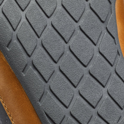 Dark gray quilted fabric with diamond pattern texture and brown leather trim visible on edge.