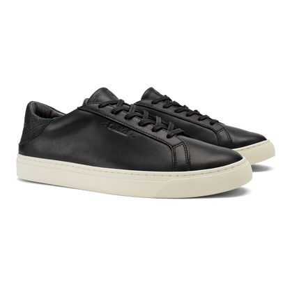 Black leather lace-up sneaker with cream rubber sole and textured heel panel.