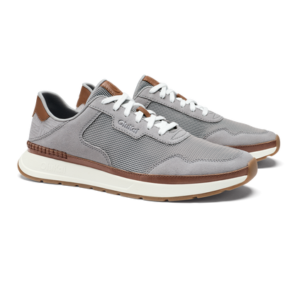 Light grey mesh and suede sneaker with brown leather trim and white laces, displayed from the side angle.