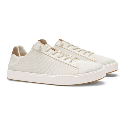 White lace-up sneaker with textured mesh upper, white sole, and tan heel tab.