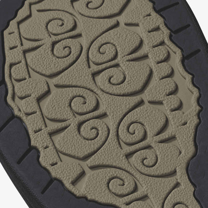 Warm taupe sole with embossed scrolling pattern and black heel detail.