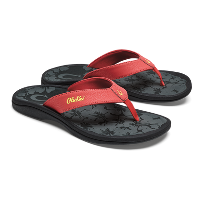 Red thong flip-flops with black patterned footbeds and yellow script text on the straps.