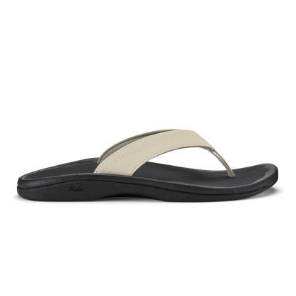 Ecru and black thong sandal with curved black sole and cushioned footbed.