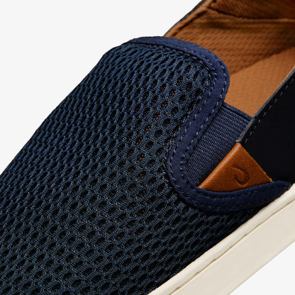 Dark blue knit slip-on shoe with tan suede heel accent and cream rubber sole.
