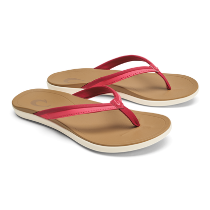 Pair of tan flip-flops with hot pink thong straps and cream-colored soles.