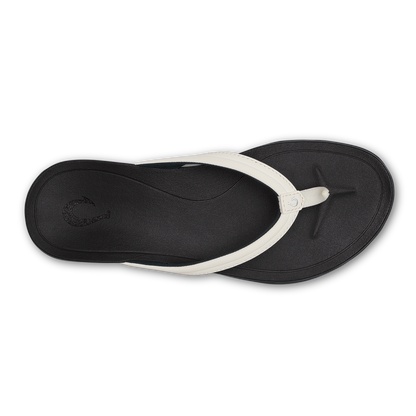 Black thong sandal with bright white strap and black footbed, shown from above.