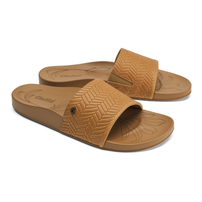 Tan slip-on sandals with chevron weave pattern upper and textured sole, shown from above at an angle.