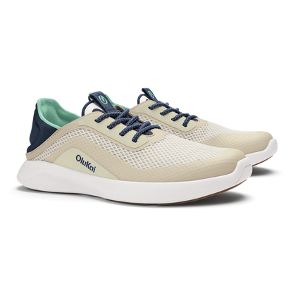 Cream and white mesh running shoe with navy laces, navy heel counter, and mint green interior lining.