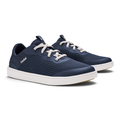 Pair of dark blue lace-up sneakers with white soles and cream-colored laces.