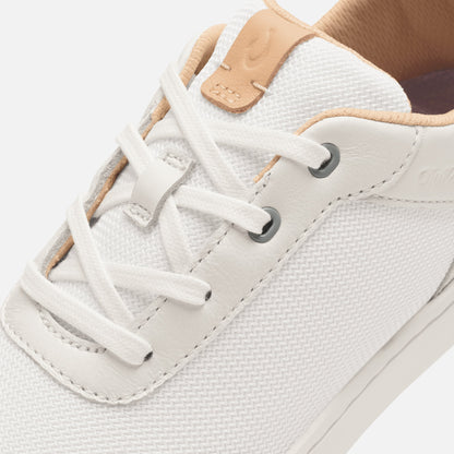 White lace-up sneaker with cantalope-colored leather heel tab and textured mesh upper.