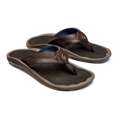 Pair of brown leather flip-flop sandals with dark footbeds, navy blue insoles, and tan rubber soles.