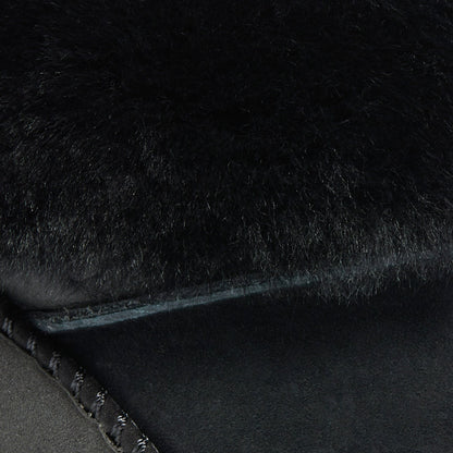 Black lava rock surface with rough, porous texture and irregular edges.